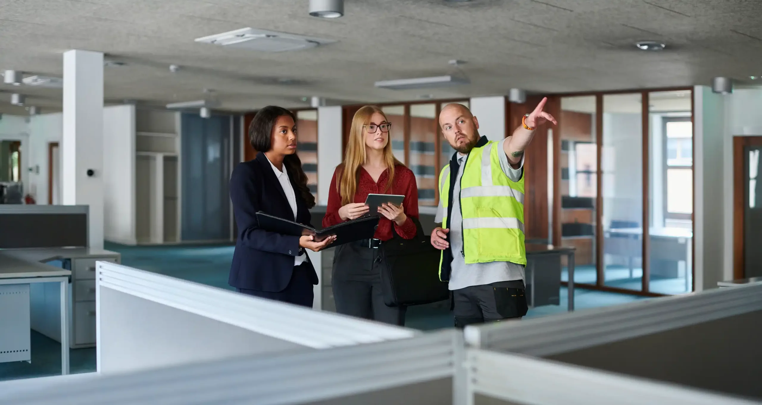 Three employees planning the new office layout